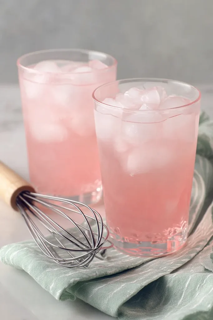 Whipped Pink Lemonade base with ice in tall glasses before adding whipped topping