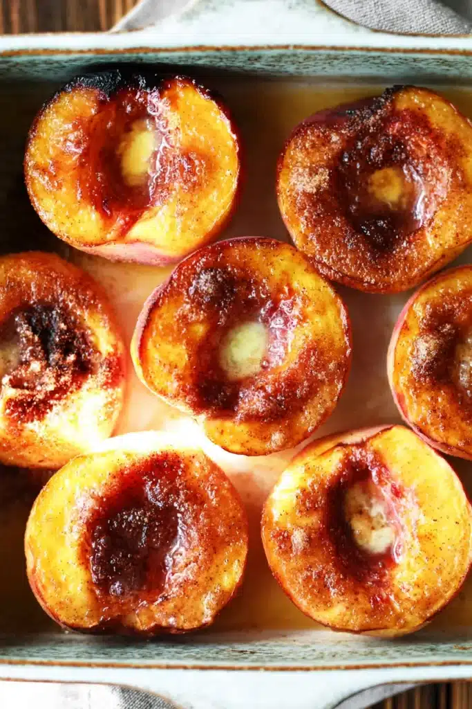 Cinnamon Sugar Baked Peaches 2 Cinnamon sugar baked peaches in baking dish with caramelized tops