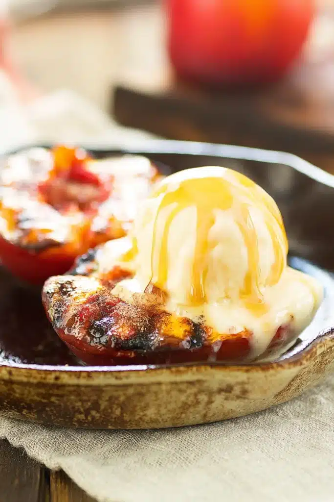 Grilled Peaches with Cinnamon and Brown Sugar 1 Grilled peaches with cinnamon sugar and melting vanilla ice cream in a skillet